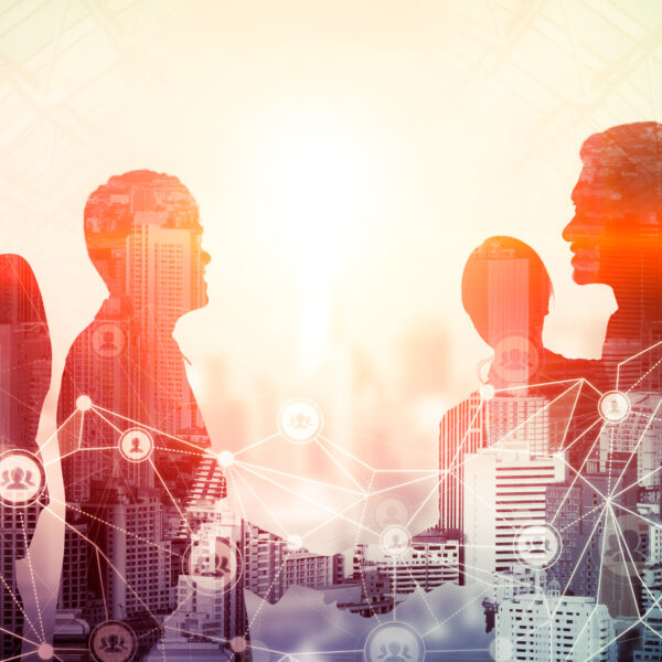 Kreatywny obraz grupy ludzi podczas konferencji na tle miejskiego biurowca, pokazujący sukces partnerstwa w transakcji biznesowej. Koncepcja pracy zespołowej, zaufania i porozumienia.